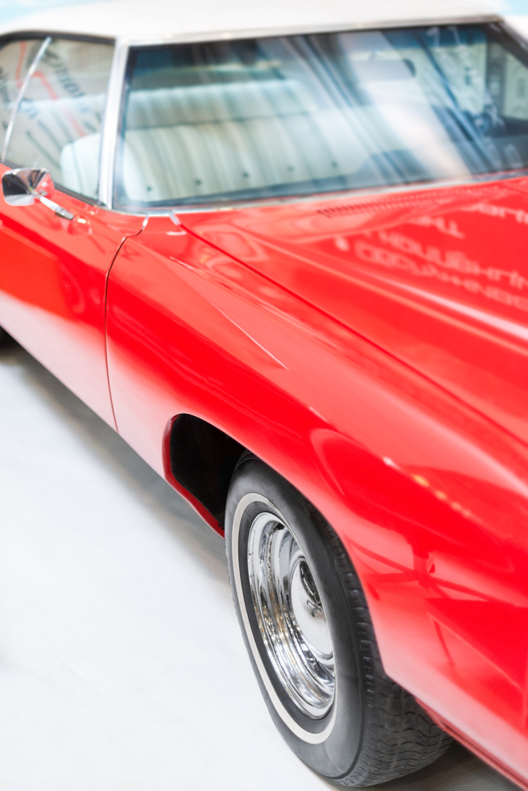 Close Up Detail of Shiny Red Classic Car. A vintage grey Volkswagen Type 3 Fastback in pristine condition, parked outdoors.